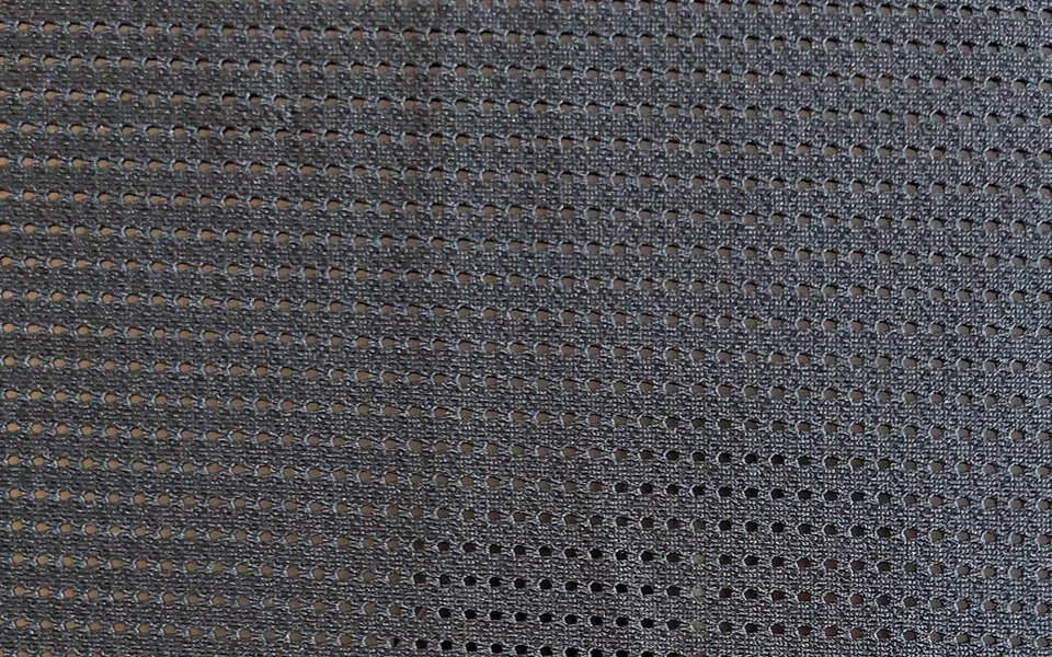 Grey mesh fabric with rows of small openings
