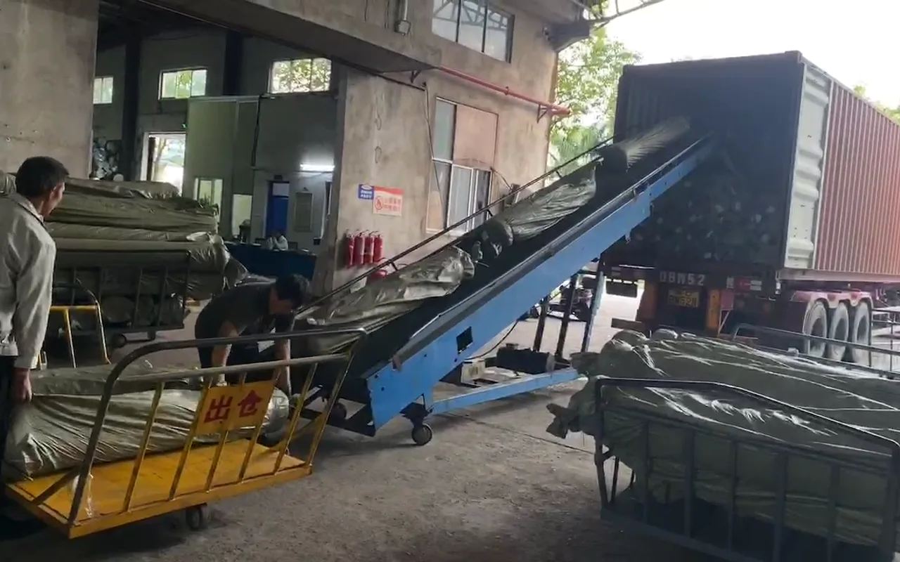 Wrapped fabric rolls moving through a loading area for dispatch