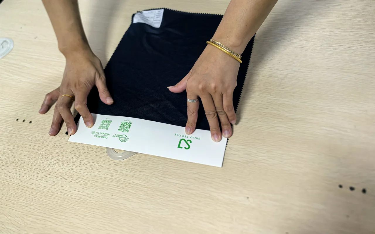 Fabric swatches and sample cards being reviewed on a work table